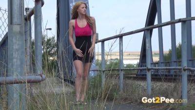 Watch this kinky European teen relieve herself near a railway track - sexu.com